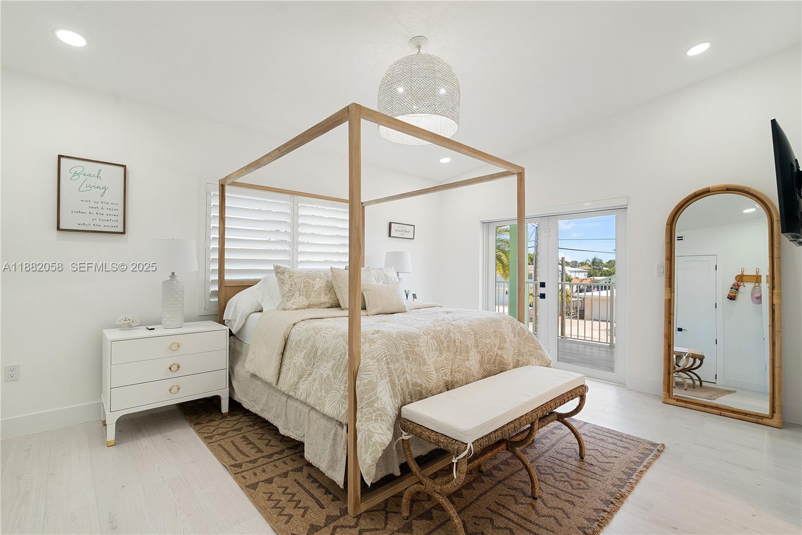 889 Ellen Drive Key Largo, FL 33037 - Photo 16 of 57 a bedroom with a bed a table and painting on the wall