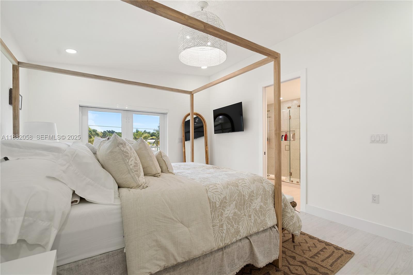 889 Ellen Drive Key Largo, FL 33037 - Photo 17 of 57 a bedroom with a bed and a flat screen tv