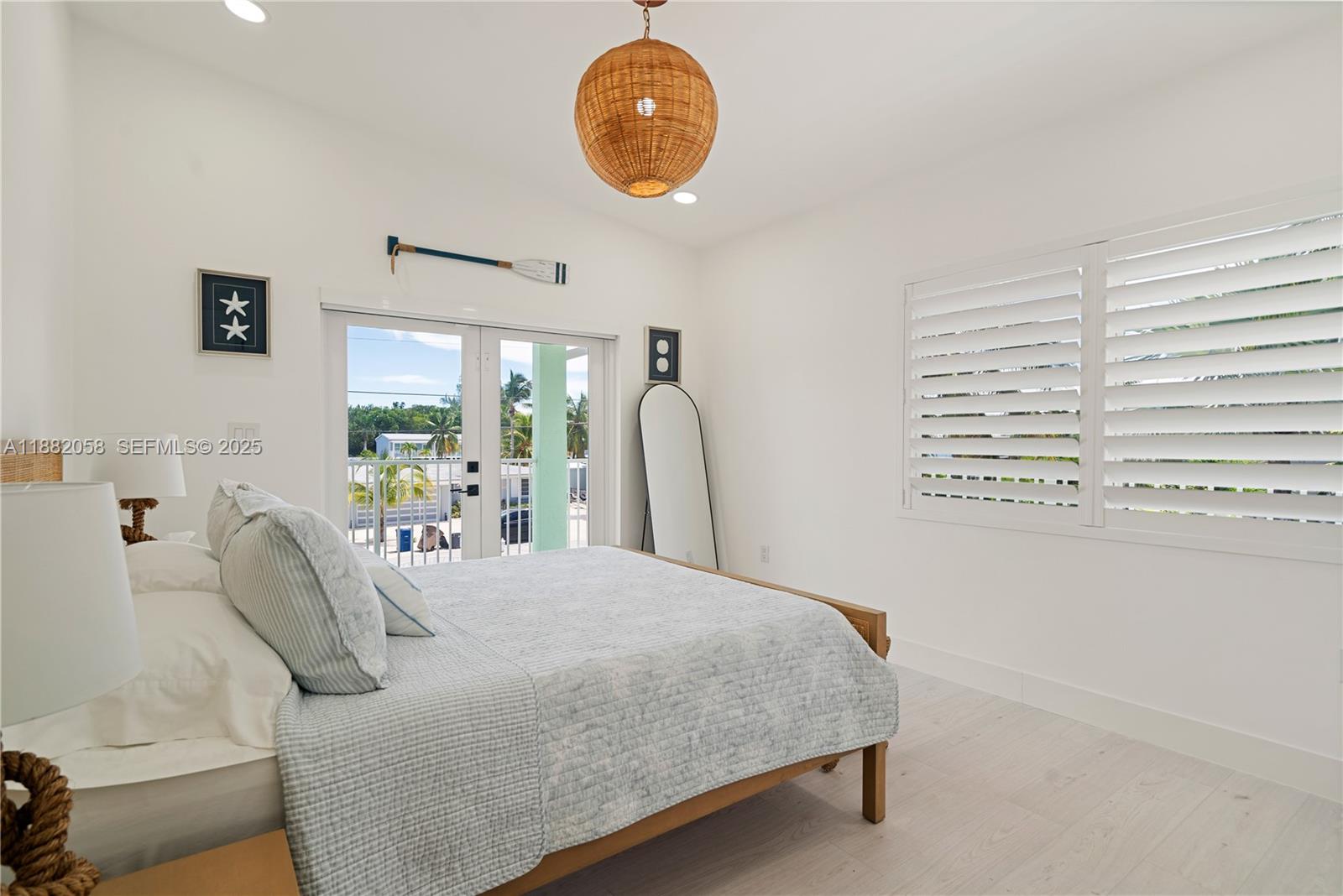 889 Ellen Drive Key Largo, FL 33037 - Photo 20 of 57 a bedroom with a bed and a large window