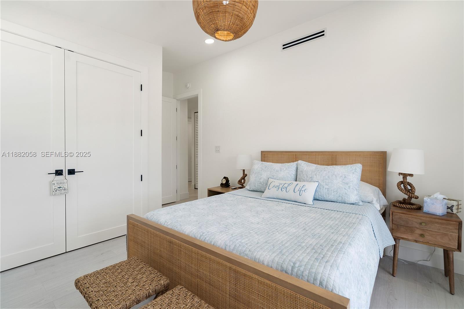 889 Ellen Drive Key Largo, FL 33037 - Photo 21 of 57 a bedroom with a bed and a chair