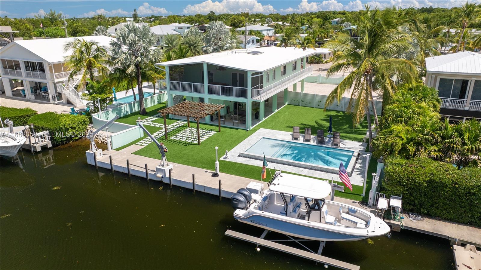 889 Ellen Drive Key Largo, FL 33037 - Photo 36 of 57 an aerial view of a house with swimming pool patio and outdoor seating