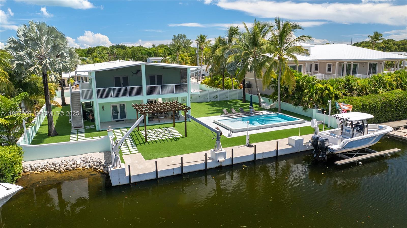 889 Ellen Drive Key Largo, FL 33037 - Photo 40 of 57 a view of house with swimming pool yard and outdoor seating