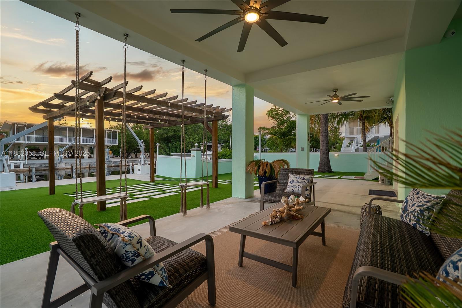 889 Ellen Drive Key Largo, FL 33037 - Photo 46 of 57 a view of a patio with a table chairs and a backyard