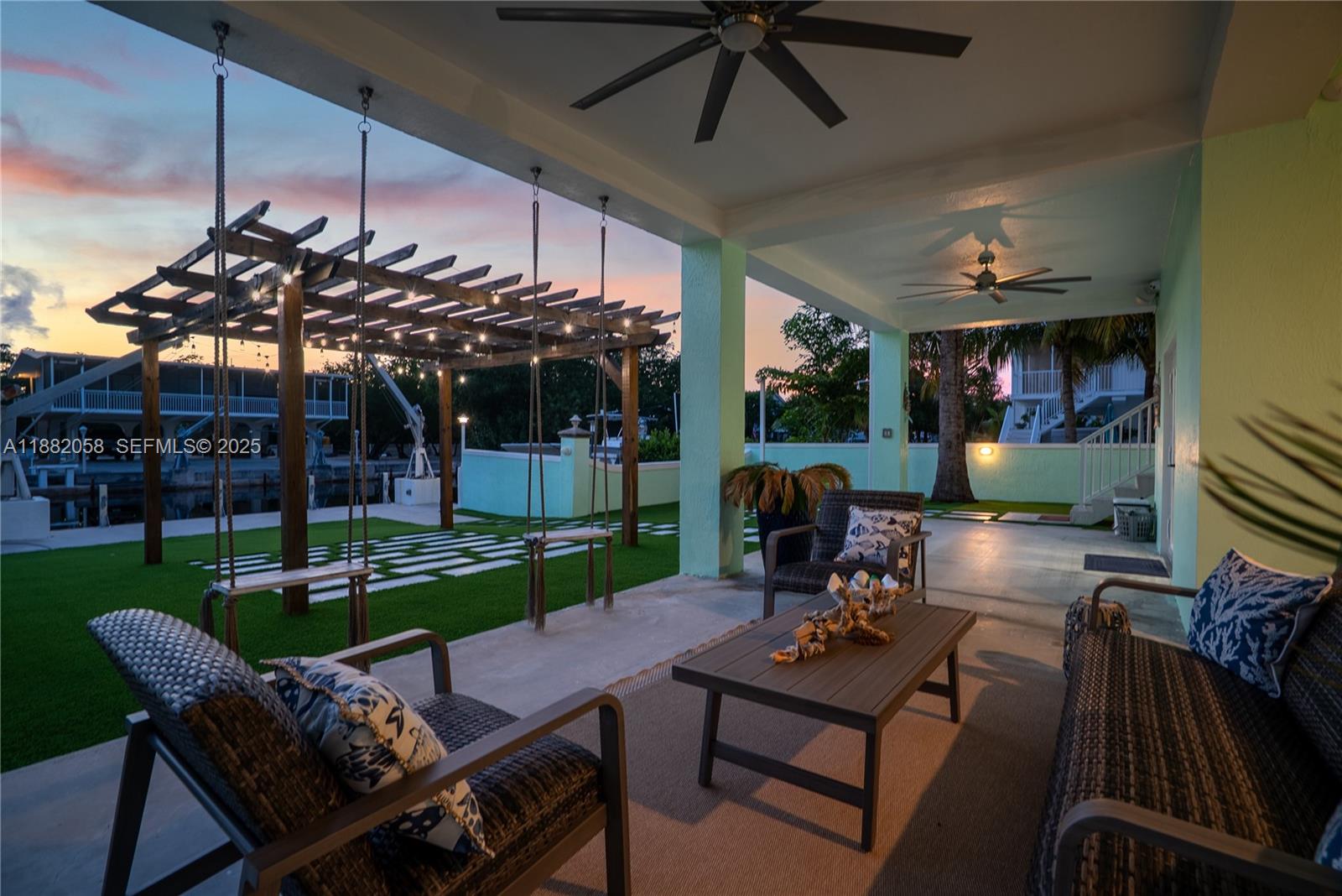 889 Ellen Drive Key Largo, FL 33037 - Photo 52 of 57 a view of a patio with a table chairs and a yard