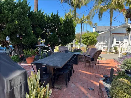 an outdoor sitting area with furniture and wooden floor