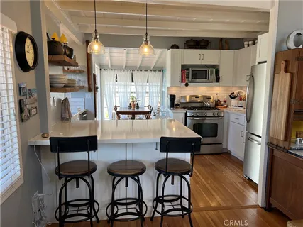 a kitchen with a refrigerator and a sink