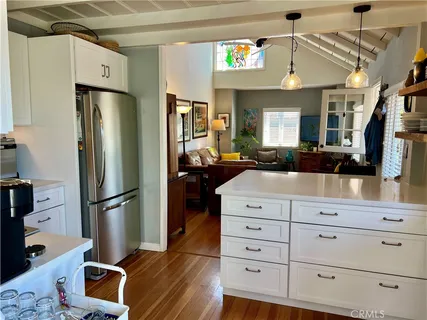 a kitchen with stainless steel appliances a stove a sink and a refrigerator