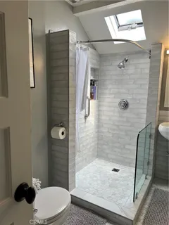 a white toilet sitting next to a bathroom sink