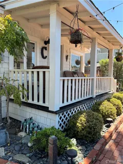 a view of a house with wooden fence next to a yard