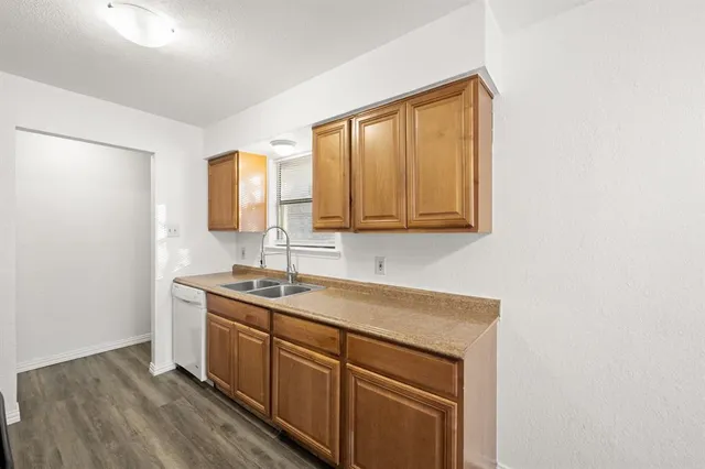 a kitchen with a sink cabinets and a window