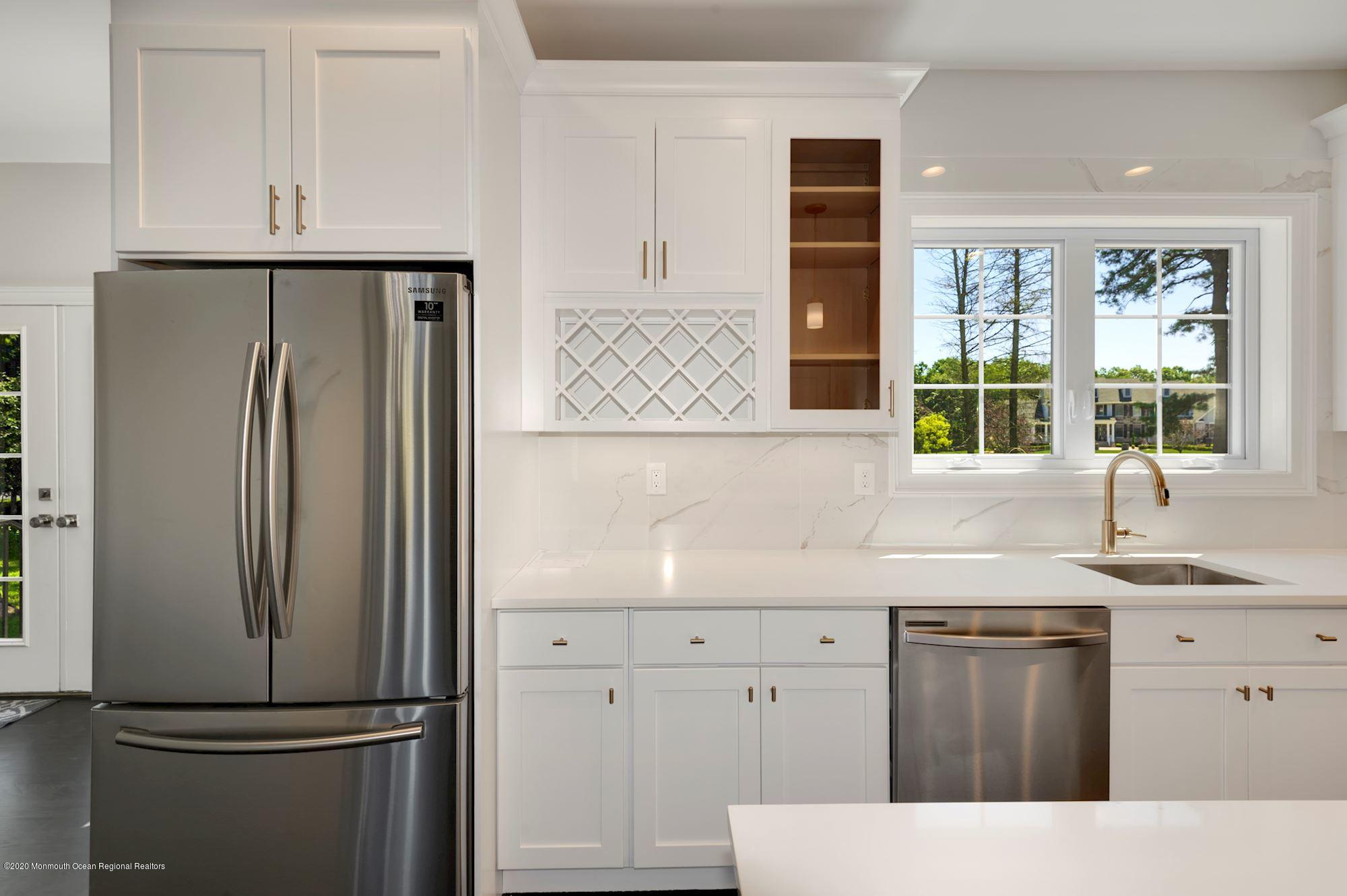 409 Jackson Mills Road Freehold, NJ 07728 - Photo 12 of 35 a kitchen with a refrigerator sink and cabinets