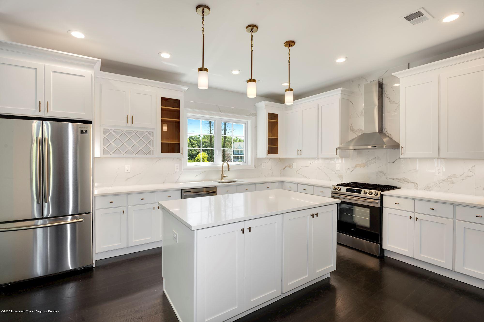 409 Jackson Mills Road Freehold, NJ 07728 - Photo 13 of 35 a kitchen with a refrigerator a sink and cabinets