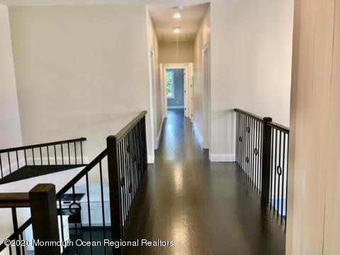 409 Jackson Mills Road Freehold, NJ 07728 - Photo 20 of 35 a view of a hallway with wooden floor and staircase