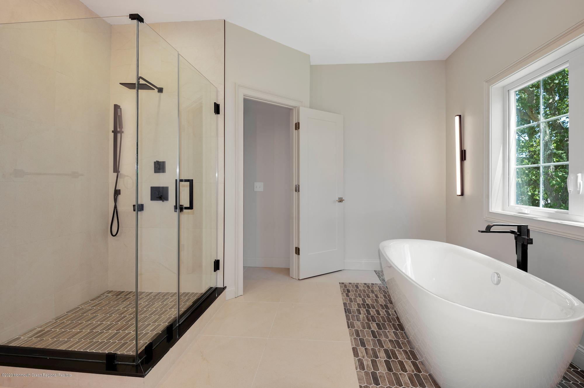 409 Jackson Mills Road Freehold, NJ 07728 - Photo 23 of 35 a bathroom with a bathtub and shower