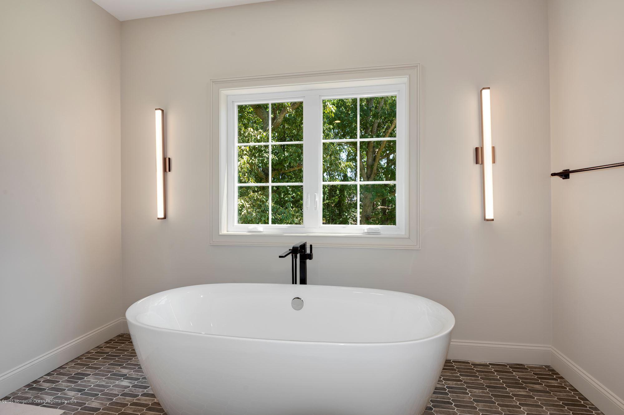 409 Jackson Mills Road Freehold, NJ 07728 - Photo 24 of 35 a white bath tub sitting next to a window