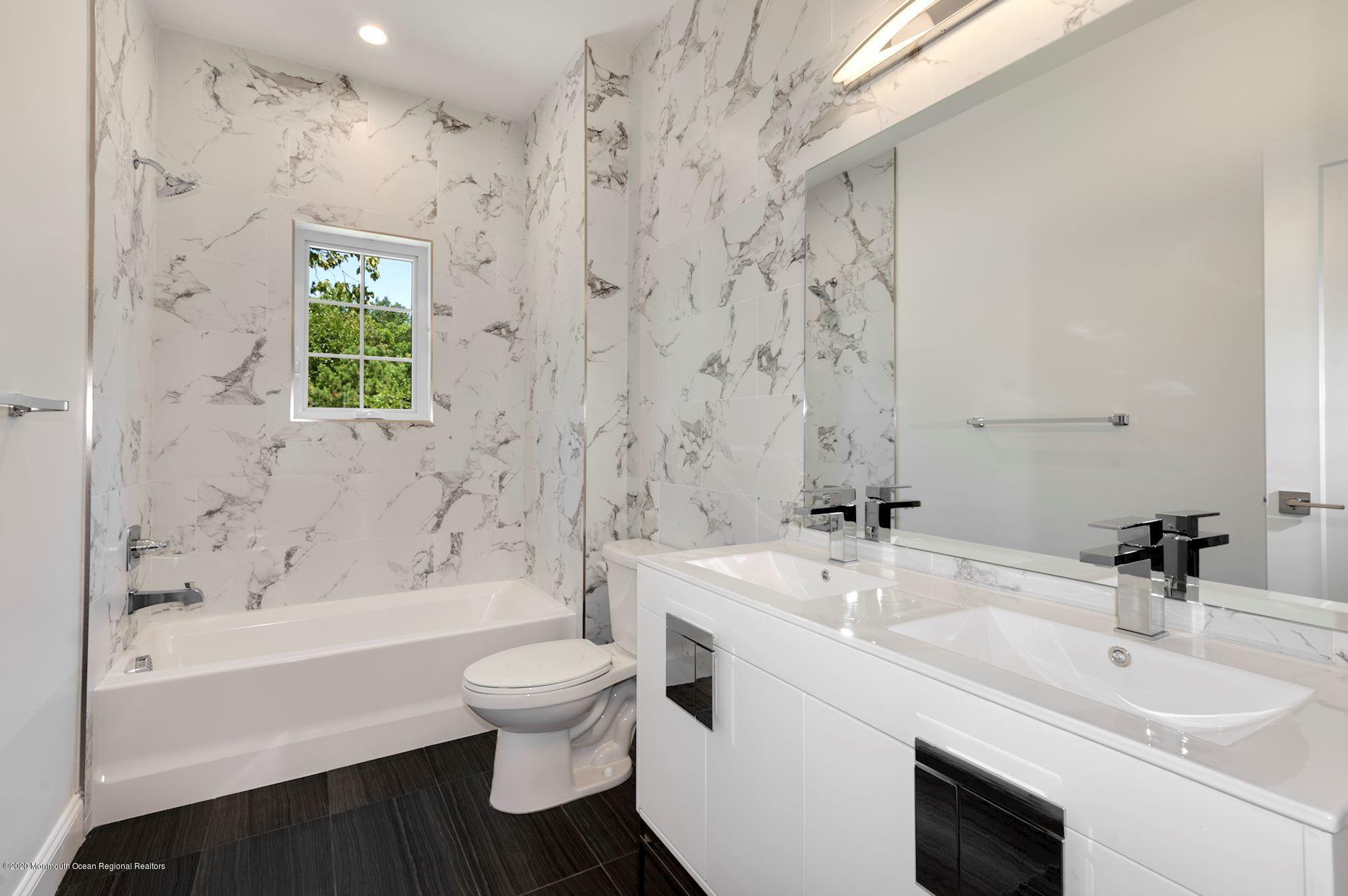 409 Jackson Mills Road Freehold, NJ 07728 - Photo 29 of 35 a bathroom with a sink a toilet and a bathtub