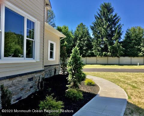 409 Jackson Mills Road Freehold, NJ 07728 - Photo 3 of 35 a view of a backyard with plants and large tree