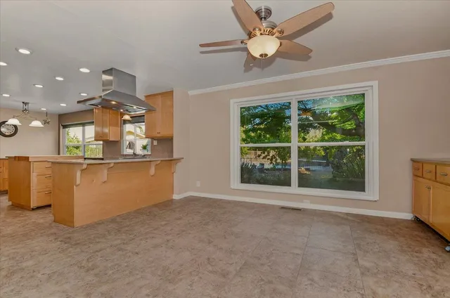 a kitchen with stainless steel appliances granite countertop a refrigerator and a stove