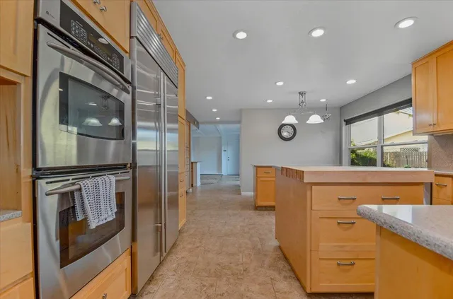 a kitchen with stainless steel appliances granite countertop a sink and a stove