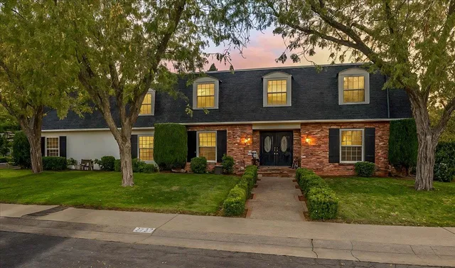 a front view of house with yard and green space