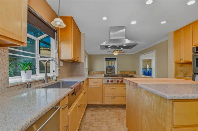 a view of an empty room with a fireplace and a window