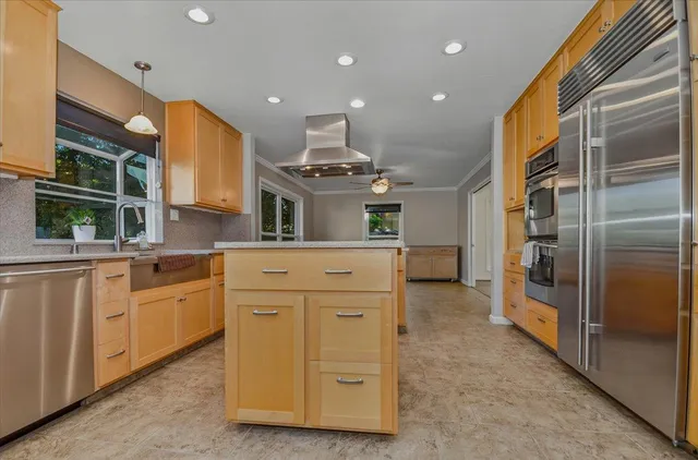 a view of a kitchen with sink and cabinets