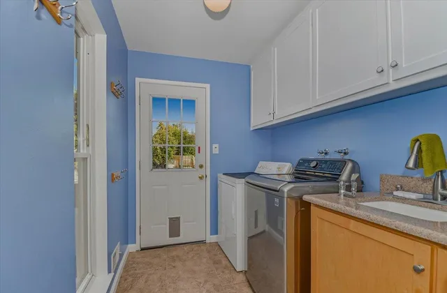 a bathroom with a granite countertop sink a mirror and a shower