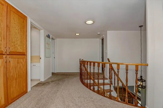 a view of a house with a yard and potted plants