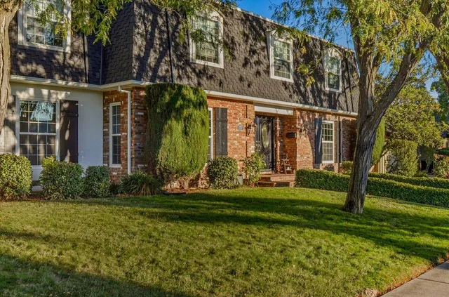 a view of empty room with wooden floor and fireplace