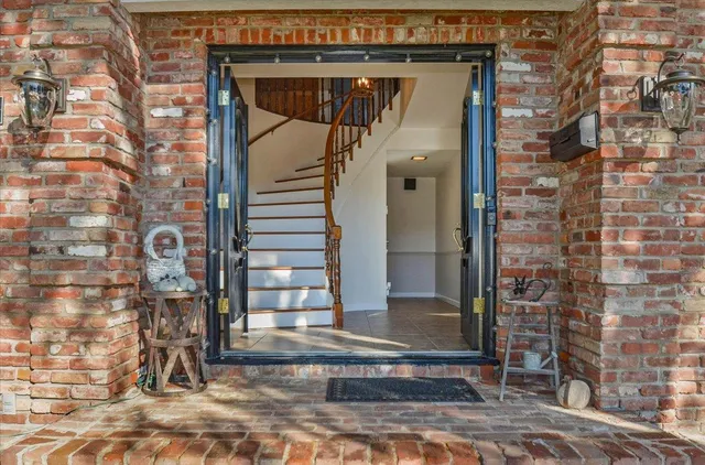a view of empty room with wooden floor and fireplace