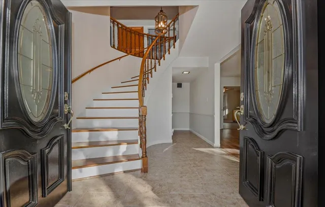 a view of empty room with wooden floor and fireplace