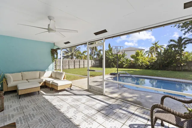 a living room with couch and a floor to ceiling window