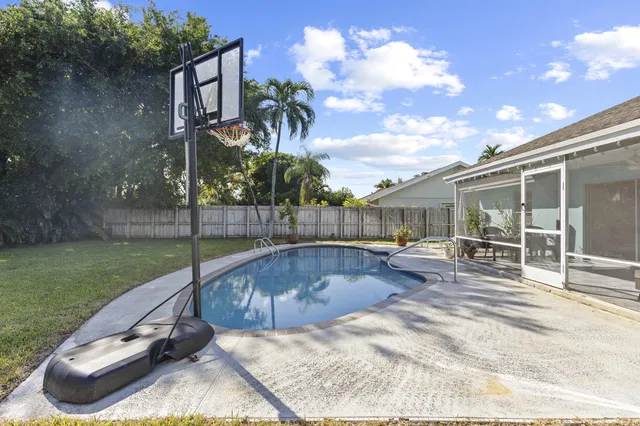 a view of a backyard with swimming pool
