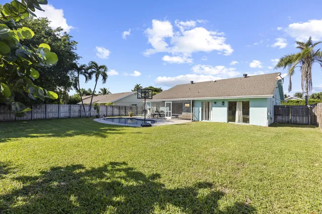 a house view with swimming pool and garden space