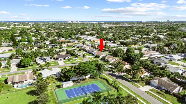 an aerial view of residential houses with outdoor space and street view