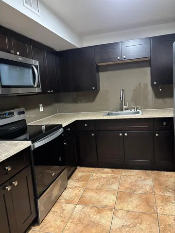 a kitchen with a sink and cabinets