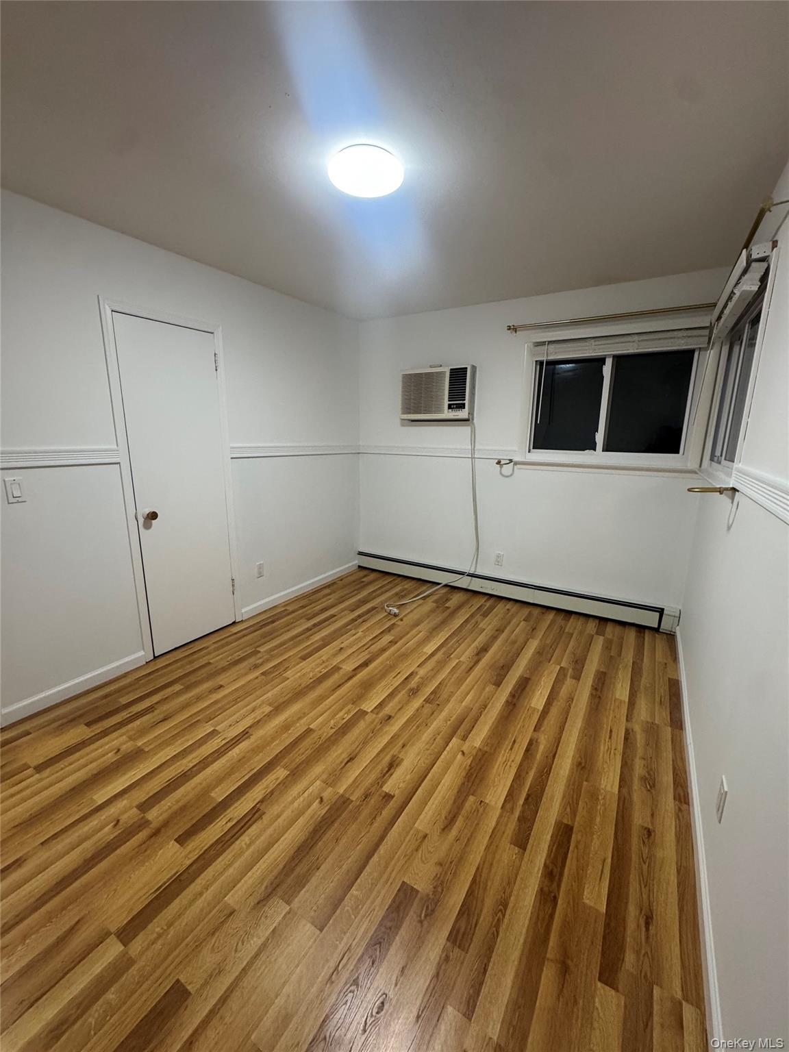 1215 America Avenue West Babylon, NY 11704 - Photo 11 of 13 a view of a room with wooden floor
