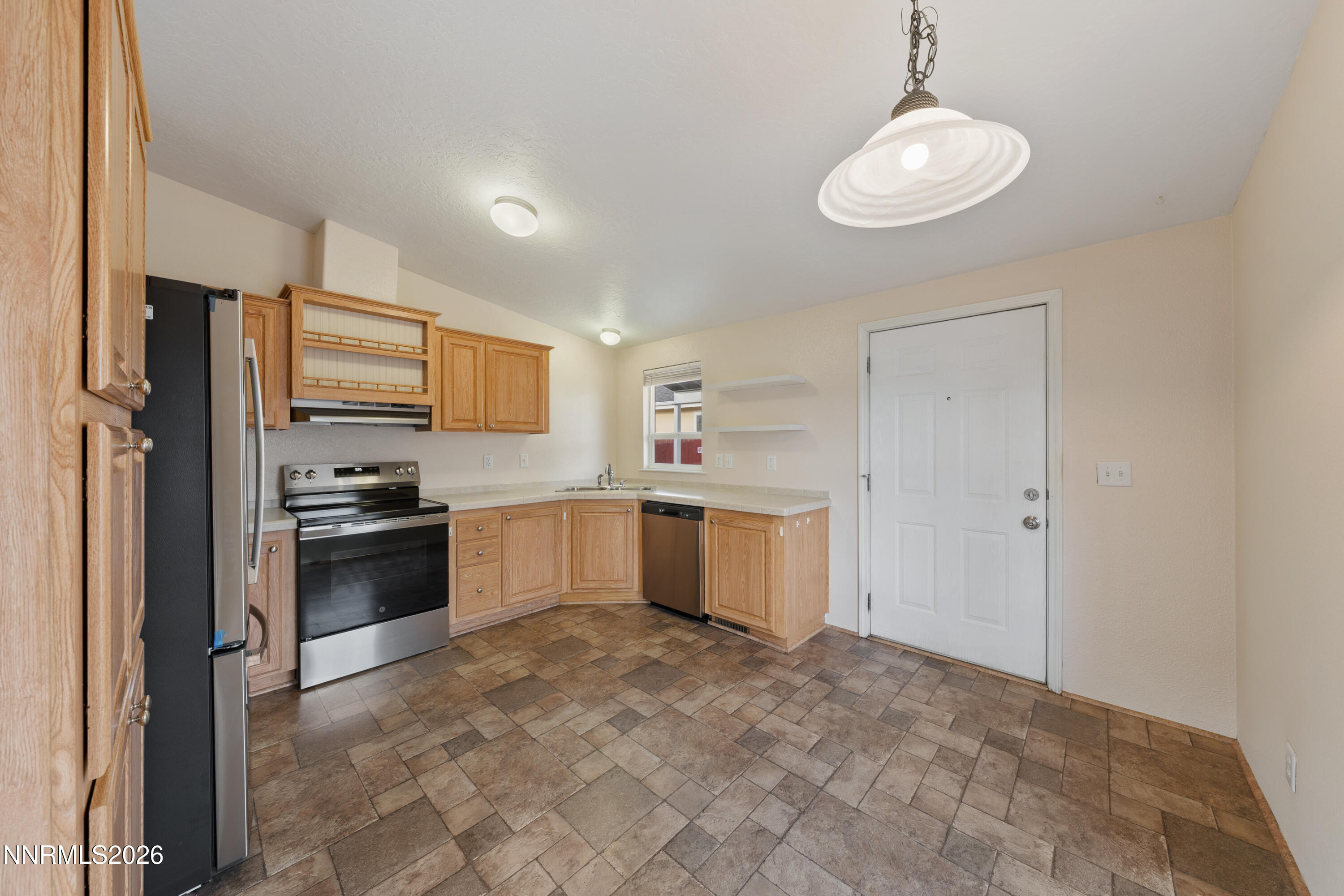 5277 Mt Dana Drive Reno, NV 89506 - Photo 6 of 49 a large kitchen with a refrigerator and a stove