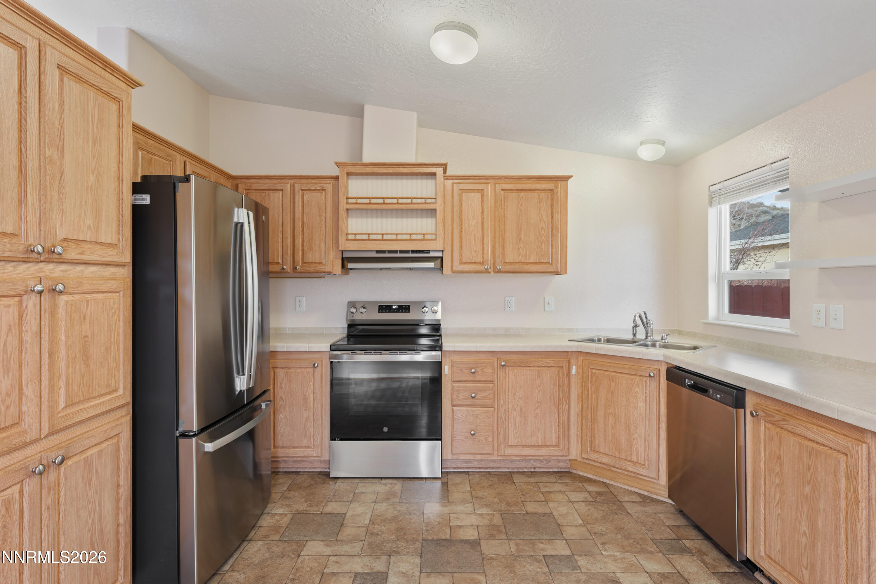 5277 Mt Dana Drive Reno, NV 89506 - Photo 7 of 49 a kitchen with stainless steel appliances granite countertop a refrigerator sink and stove