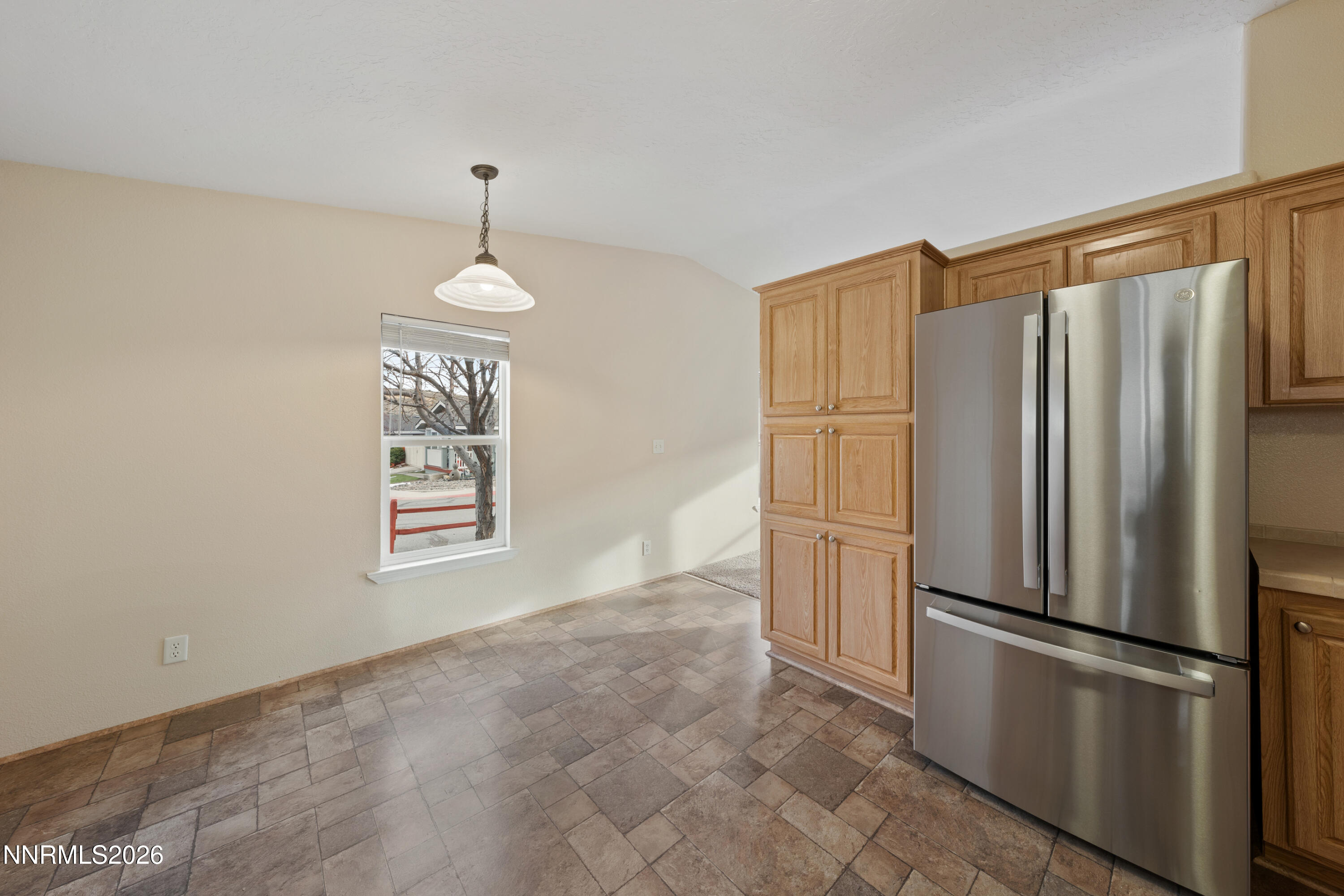 5277 Mt Dana Drive Reno, NV 89506 - Photo 9 of 49 a kitchen with stainless steel appliances a refrigerator sink and cabinets