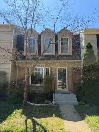 a front view of a house with yard and garage