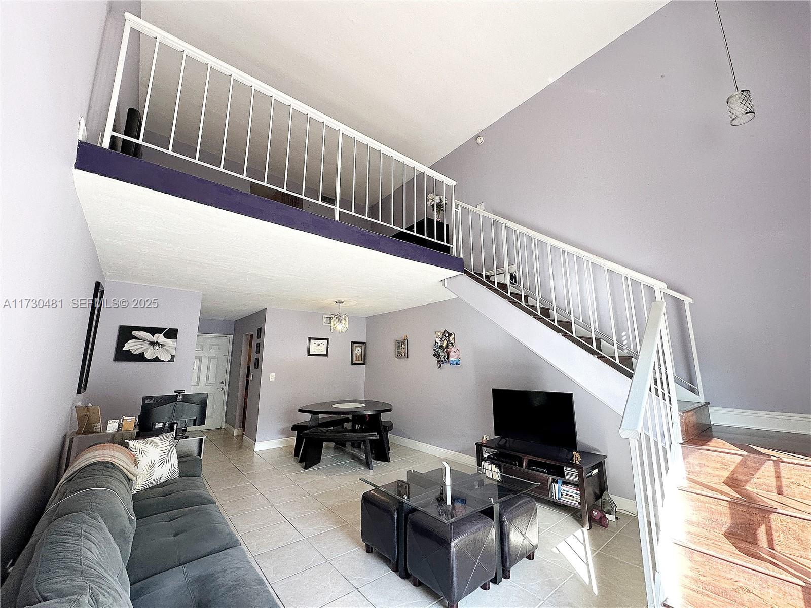 8550 Southwest 109th Avenue, Unit 5217 Miami, FL 33173 - Photo 1 of 16 a living room with furniture and a flat screen tv