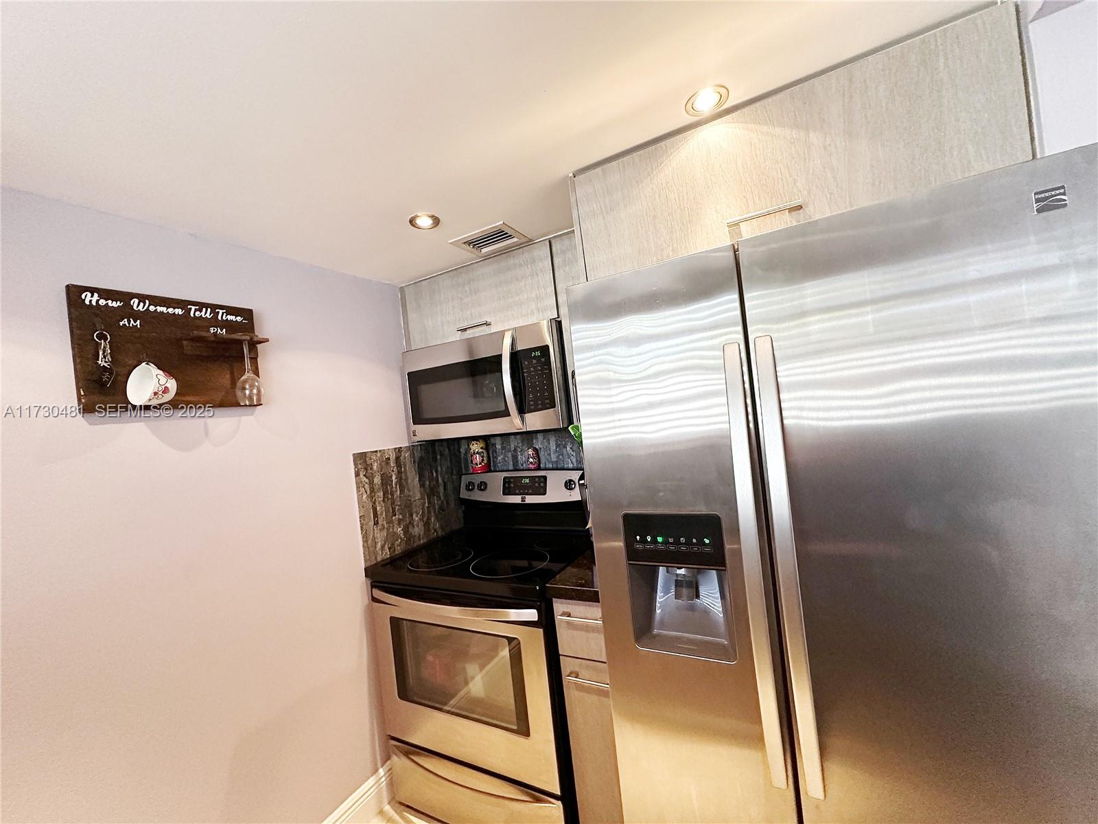 8550 Southwest 109th Avenue, Unit 5217 Miami, FL 33173 - Photo 3 of 16 a kitchen with stainless steel appliances granite countertop a refrigerator and a stove