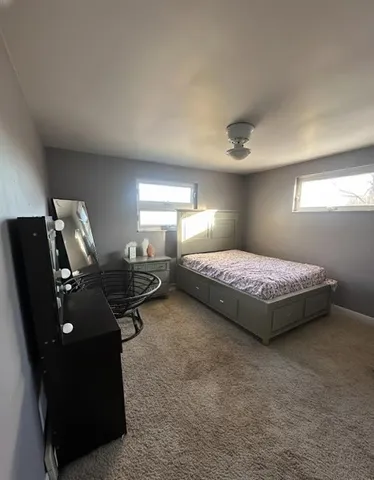 a bedroom with bed and window