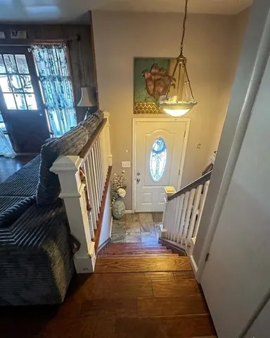 a view of entryway and hall with wooden floor