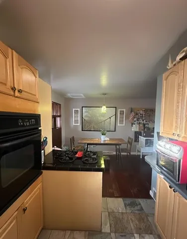 a kitchen with granite countertop a stove and a refrigerator