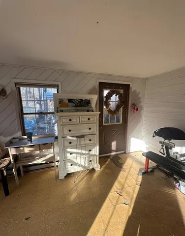 a bedroom with furniture and a flat screen tv