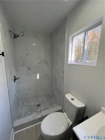 a white toilet sitting next to a bath tub shower