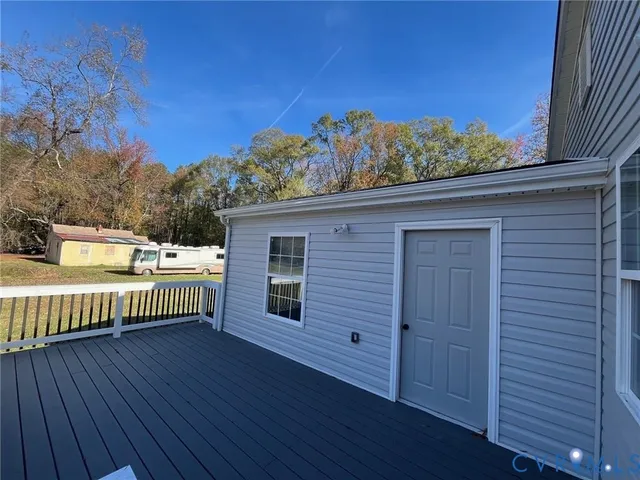 a view of a roof deck with wooden floor and fence