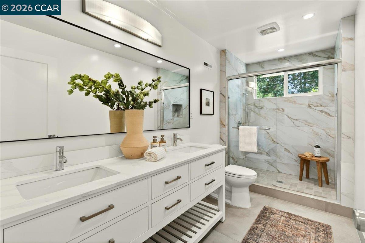 24 Las Vegas Road Orinda, CA 94563 - Photo 25 of 47 a bathroom with a double vanity sink toilet and a mirror